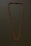 Rudraksha mala necklace with dark red-brown beads and gold tone end caps