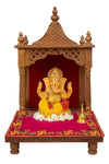 Pink pooja asan mat on wooden altar stand, with golden border and embroidered motifs.
