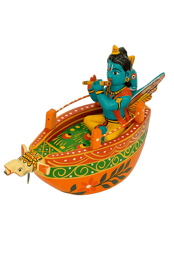 Painted wooden boat with blue bird figure and yellow drum, orange hull with green and red patterns