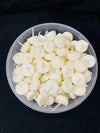 Ghee wick pieces in a shallow dish, pale cream round wicks
