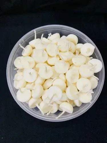 Ghee wick pieces in a shallow dish, pale cream round wicks