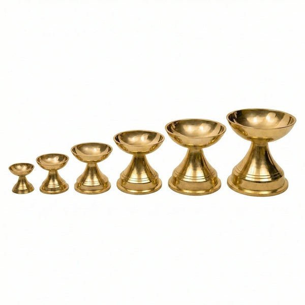 Set of brass diya oil lamps in varying sizes, from small to large