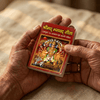 Small pocket book with devotional Gita cover held in hands