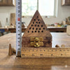 Wooden dhoop holder with brass latch, pyramid pinhole top, shown with ruler