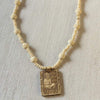 Tulsi mala necklace close-up with white beads and square Hanuman pendant