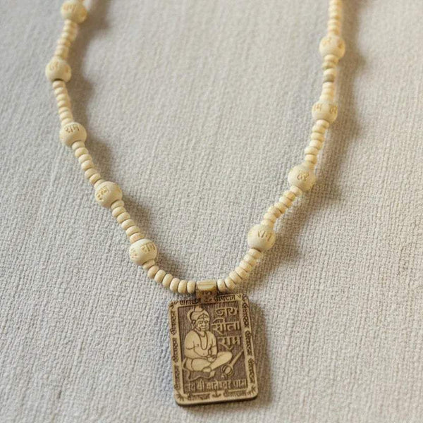 Tulsi mala necklace close-up with white beads and square Hanuman pendant