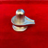 Silver-toned shivling stand with domed top and side spout, angled close-up