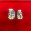 Pair of metal Nandi bull figurines, close side view with patterned saddles, silver finish