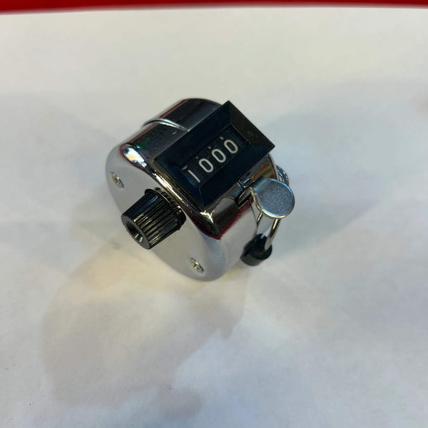 Angled metal tally counter with finger ring, digit window showing 1000
