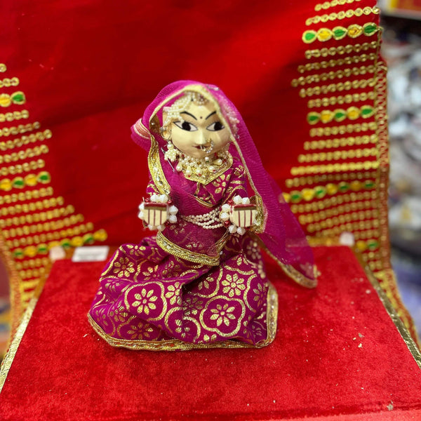 Wooden Radha pooja idol, seated in purple sari with gold detailing on red base