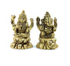 Two Hindu sculptures, one depicting Lord Ganesha and the other Goddess Lakshmi, seated on a lotus flower base, in a golden color.