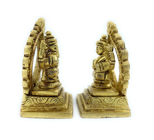 Gold-toned Laxmi-Ganesh singhasan, paired seated deities with curved halos, angled view