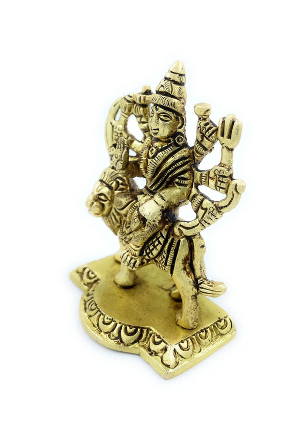 Durga Mata statue, seated on lion with many arms raised, gold-toned metal, front angle