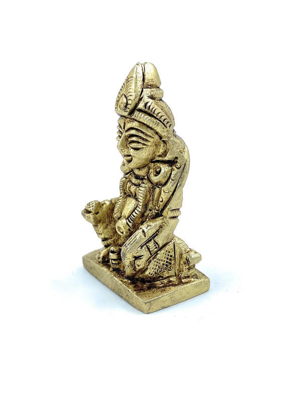 Kuber deity idol small figurine, angled view with raised hands and crown