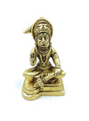 Gold-tone Hanuman statue seated on pedestal, hands folded in front