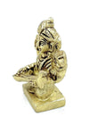 Gold-toned Saraswati deity idol, seated with veena across lap, rear view