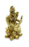 Golden Saraswati figurine holding veena, seated with one hand raised in blessing