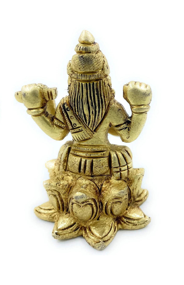 Golden Saraswati figurine back view, long hair and veena held across lap