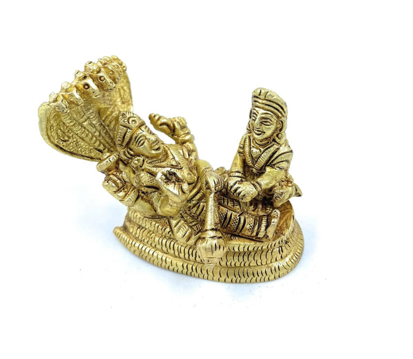 Gold-tone Vishnu and Laxmi figurine seated on coiled serpent, raised arms