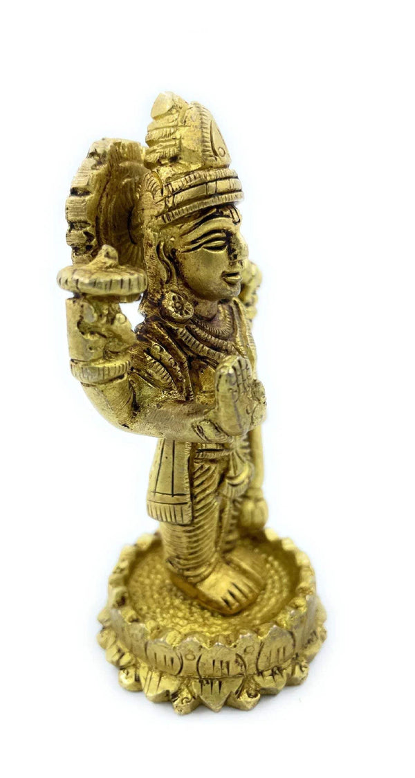 Gold-toned Vishnu idol side view, standing figure with carved jewelry and halo