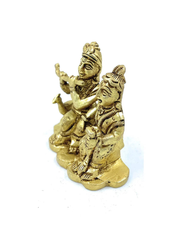 Gold-tone Radha-Krishna style figurine, two figures with arms raised and jewelry