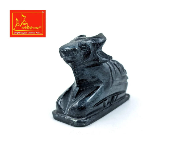 Black marble Nandi figurine, angled close-up with detailed carving
