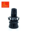 Dark marble shivling on pedestal base with carved ring detail around the top.