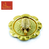 Gold turtle figurine on round decorative plate, close-up top view