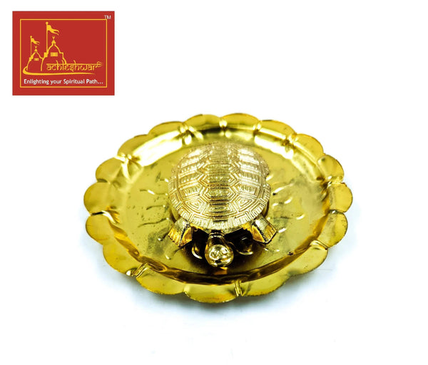 Gold tone turtle plate with central sunburst medallion and three small beaded accents