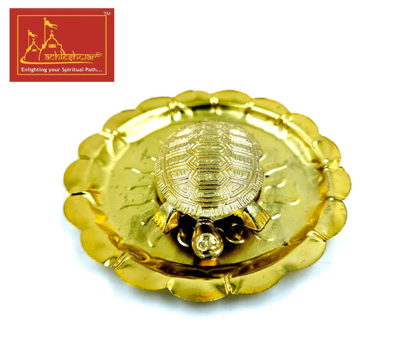 Gold tone turtle-shaped plate with central sun-and-Om medallion and three beads