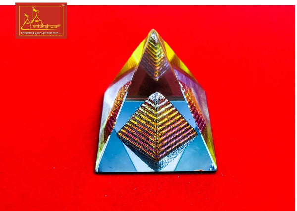 Crystal pyramid with rainbow striped facets, angled top view.