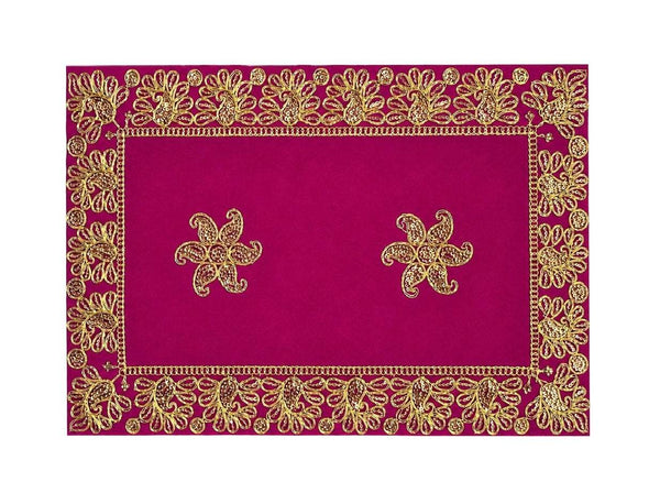 Close-up of maroon velvet pooja aasan with gold embroidered rectangular frame and two flower motifs