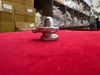 Small metallic shivling ornament on red fabric with rounded base