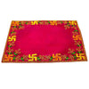 Pink velvet pooja asan with golden frame border and green-gold embroidered pattern.