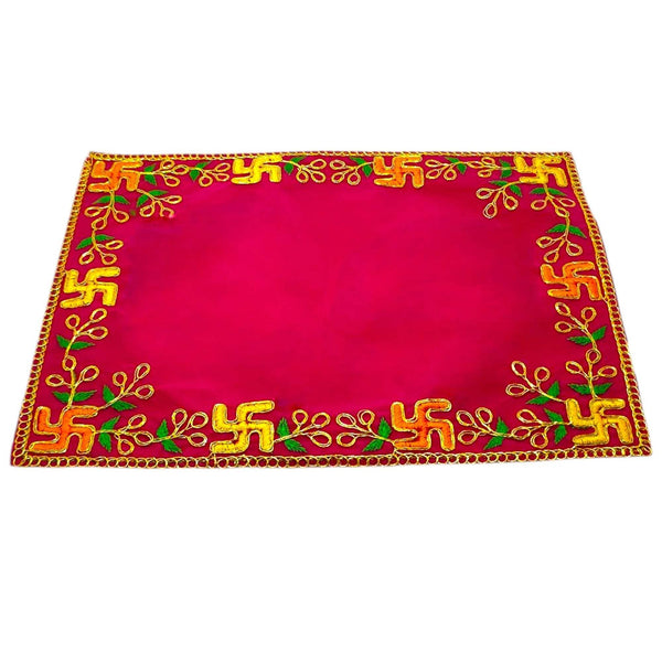Pink velvet pooja asan with golden frame border and green-gold embroidered pattern.