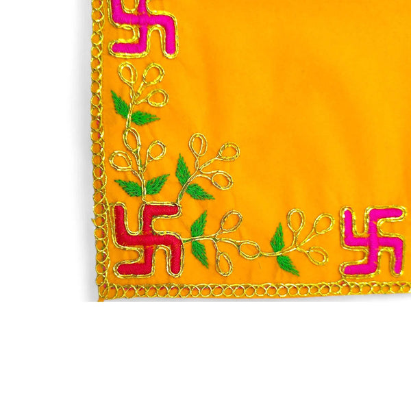 Close-up of yellow pooja velvet chowki aasan corner with embroidered multicolor motifs