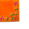 Orange pooja asan cloth corner with pink and purple motif, green vines and gold trim
