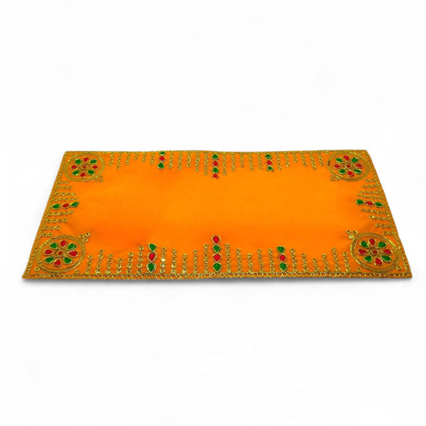 Angled yellow velvet pooja aasan cloth with golden embroidered border and corner motifs