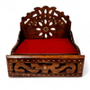 Wooden sofa cum bed with carved backrest and red cushion, front storage panel