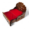 Wooden sofa cum bed with red padded seat and carved side panels, angled view