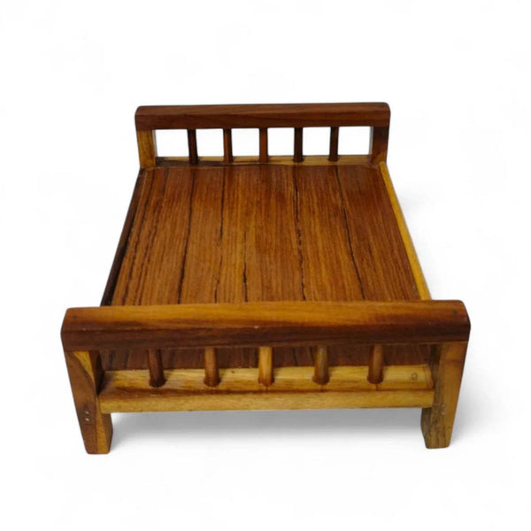 Wooden charpai with slatted backrest and peg-style posts, dark brown.