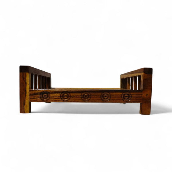 Wooden charpai bed frame with carved front rail and slatted ends, dark brown.