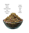 Hawan samagri mixture in a teal bowl, with dried herbs and rose petal pieces