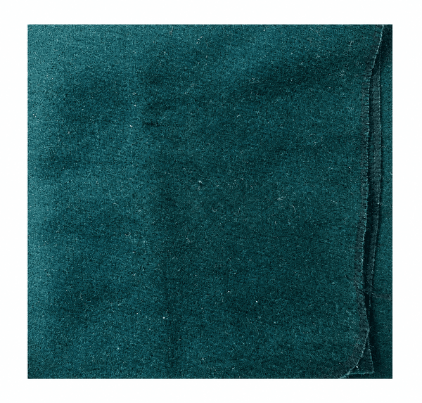 Green woolen pooja asan square mat, textured teal fabric close-up