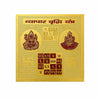 Gold yantra card with two seated deity figures and geometric symbol grid