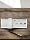 Open panchang book with two printed pages and date grid
