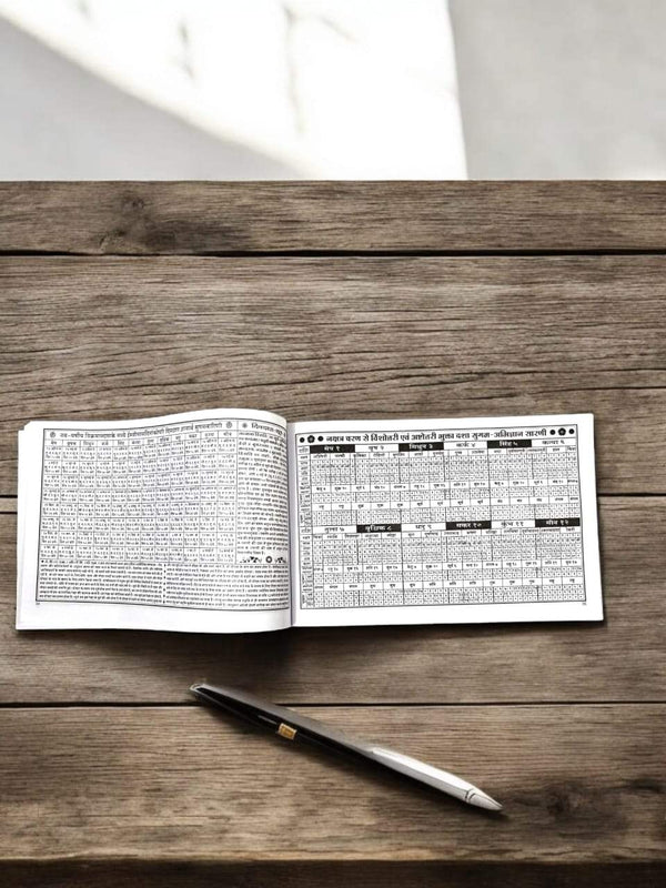 Open panchang book with two printed pages and date grid