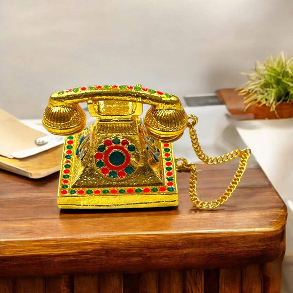 Golden miniature metal telephone toy with gem inlay and gold chain cord