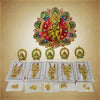Jeweled deity crown with red, green and purple stones; earring set displayed in cards.