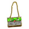Miniature jeweled purse with green enamel front and red oval gem, gold chain handle.